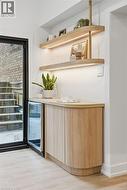 Built-in wood-finish cabinetry featuring a beverage refrigerator - 