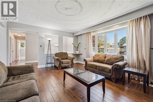 Living room featuring wood-finish flooring and a decorative ceiling medallion - 47 Oakhurst Crescent, Kitchener, ON - Indoor Photo Showing Living Room