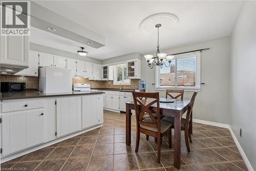 Kitchen featuring white cabinetry, dark countertops, tiled backsplash, and recessed lighting - 47 Oakhurst Crescent, Kitchener, ON - Indoor