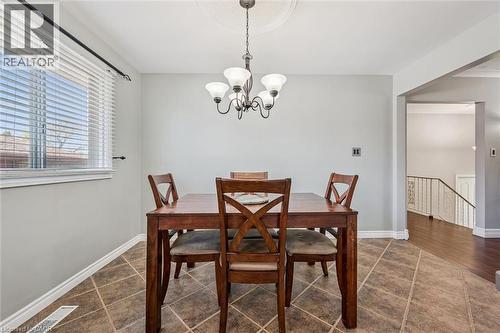 Dining area featuring a decorative ceiling medallion and a multi-arm chandelier - 47 Oakhurst Crescent, Kitchener, ON - Indoor Photo Showing Dining Room