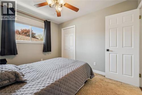 Carpeted bedroom with a window featuring horizontal blinds - 47 Oakhurst Crescent, Kitchener, ON - Indoor Photo Showing Bedroom