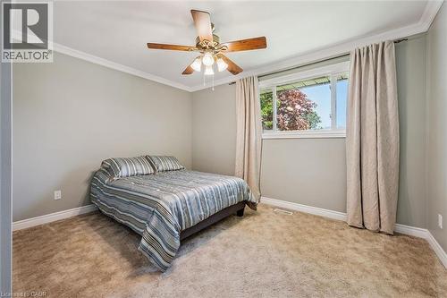 Broadloom carpeting, crown molding, and a ceiling fan with integrated lighting - 47 Oakhurst Crescent, Kitchener, ON - Indoor Photo Showing Bedroom