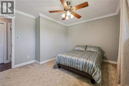 Bedroom featuring neutral wall paint, carpet flooring, crown molding, and a ceiling fan with integrated lighting - 47 Oakhurst Crescent, Kitchener, ON - Indoor Photo Showing Bedroom