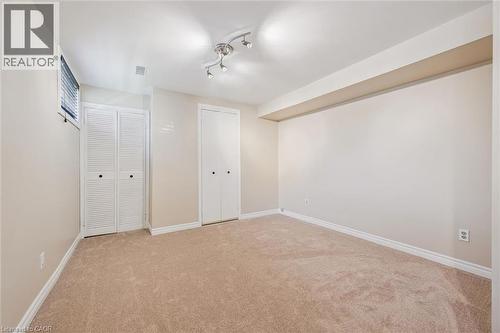 Newly carpeted room with ensuite, featuring neutral-toned walls, white baseboards - 47 Oakhurst Crescent, Kitchener, ON - Indoor Photo Showing Other Room
