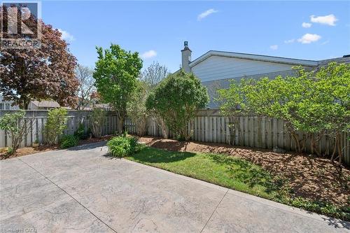 Expansive stamped concrete patio with surrounding privacy fencing - 47 Oakhurst Crescent, Kitchener, ON - Outdoor