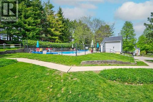 Inground community pool steps from the unit - 270 Morrison Road Unit# 7C, Kitchener, ON - Outdoor With In Ground Pool