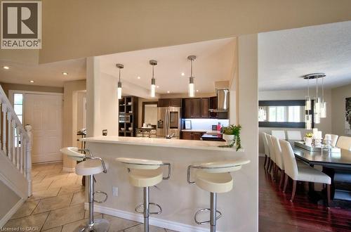 Breakfast bar with bar stools - 270 Morrison Road Unit# 7C, Kitchener, ON - Indoor Photo Showing Other Room