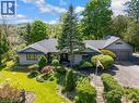 Stone façade residence with a multi-car garage, mature landscaping, and a sloped roofline - 91 Limerick Drive, Kitchener, ON  - Outdoor With Facade 