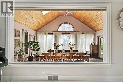 Vaulted wood-paneled ceiling, large arched window, multiple windows with sheer drapery, and wood-finish flooring - 91 Limerick Drive, Kitchener, ON - Indoor Photo Showing Other Room