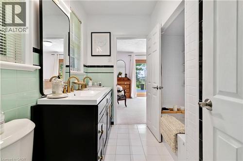 Double vanity featuring white rectangular sinks and gold-finish faucets - 91 Limerick Drive, Kitchener, ON - Indoor Photo Showing Bathroom