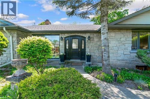 Stone facade entry with a dark double door featuring arched top lites - 91 Limerick Drive, Kitchener, ON - Outdoor