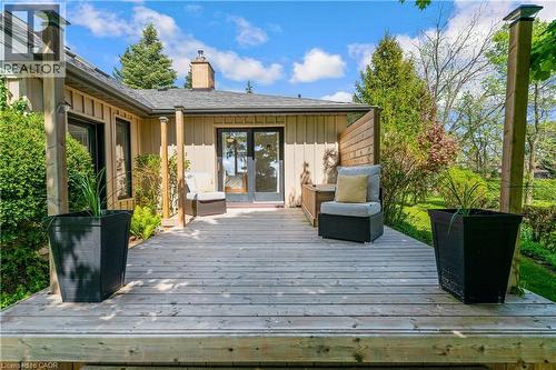 Spacious wood-plank deck featuring a wooden privacy screen and multiple access points to the residence - 91 Limerick Drive, Kitchener, ON - Outdoor With Deck Patio Veranda With Exterior