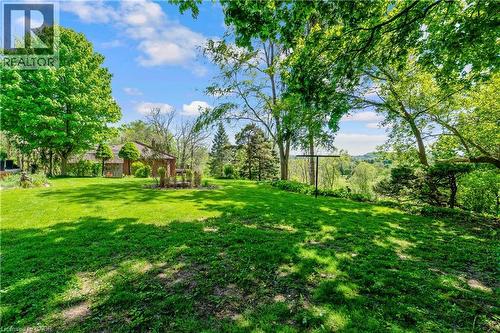 Expansive green lawn with mature trees and a distant wooded landscape - 91 Limerick Drive, Kitchener, ON - Outdoor