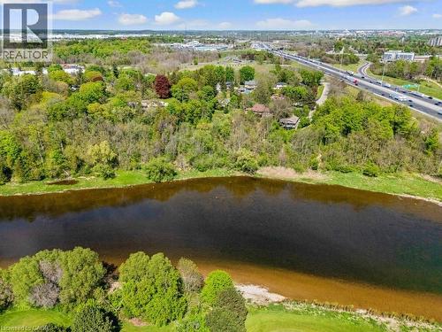 Waterfront property featuring a substantial body of water, lush green shoreline, and extensive mature trees - 91 Limerick Drive, Kitchener, ON - Outdoor With Body Of Water With View