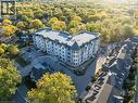 Modern multi-story building featuring a distinctive curved facade and multiple balconies - 2 Arbourvale Common Unit# 410, St. Catharines, ON  - Outdoor With View 