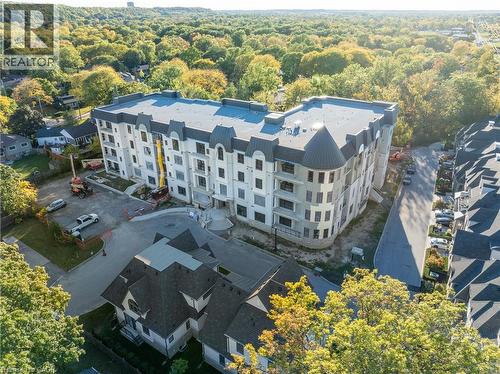 Multi-story building featuring a prominent turret and multiple balconies - 2 Arbourvale Common Unit# 410, St. Catharines, ON - Outdoor With View