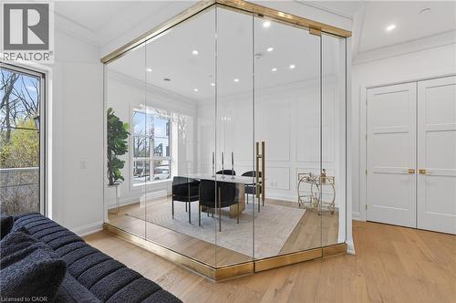 Glass-enclosed room with brass accents, light wood-finish flooring, recessed lighting, and white paneled walls - 2 Arbourvale Common Unit# 410, St. Catharines, ON - Indoor