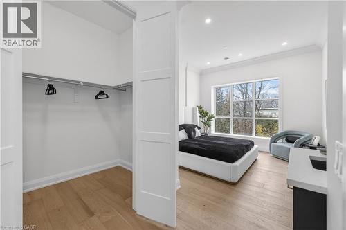 Spacious room with large windows, recessed lighting, crown molding, and wood-finish flooring - 2 Arbourvale Common Unit# 410, St. Catharines, ON - Indoor