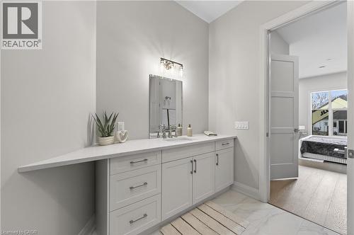 Spacious vanity with light gray cabinetry, a white countertop, and a rectangular undermount sink - 2 Arbourvale Common Unit# 410, St. Catharines, ON - Indoor Photo Showing Bathroom