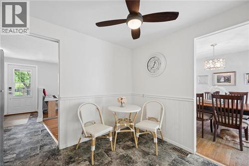 Corner dining nook featuring wainscoting and a ceiling fan with integrated lighting - 50 Lewis Crescent, Kitchener, ON - Indoor Photo Showing Dining Room