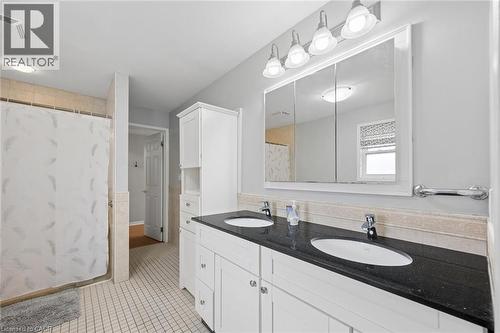 Bathroom featuring a dual-sink vanity with a dark countertop and white cabinetry - 50 Lewis Crescent, Kitchener, ON - Indoor Photo Showing Bathroom