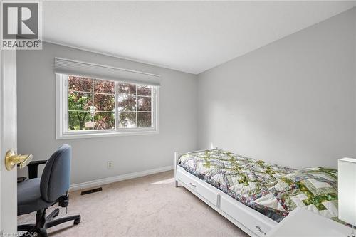 Light-filled room featuring wall-to-wall carpeting, a large window with horizontal blinds, and neutral wall tones - 50 Lewis Crescent, Kitchener, ON - Indoor Photo Showing Bedroom