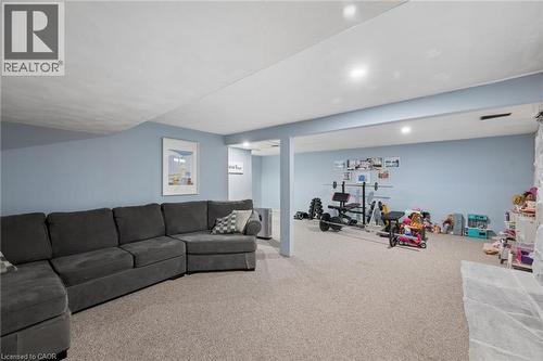 Spacious lower-level area featuring light-toned carpeting and soft blue walls - 50 Lewis Crescent, Kitchener, ON - Indoor Photo Showing Living Room