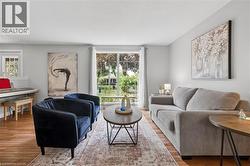 Living area featuring wood-finish flooring and light gray painted walls - 