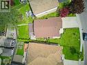 Residential property featuring a brown shingle roof, a concrete driveway, and a verdant lawn - 459 Dicenzo Drive, Hamilton, ON  - Outdoor 