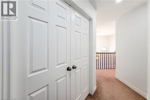 White paneled bi-fold doors with dark hardware - 197 Cloverleaf Drive, Ancaster, ON - Indoor Photo Showing Other Room