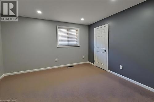 Room featuring neutral tone carpeting and contrasting wall colors - 197 Cloverleaf Drive, Ancaster, ON - Indoor Photo Showing Other Room