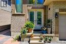 Brick exterior featuring a double-door entry with decorative glass inserts, a two-story window, a garage door with panel detailing, and a black exterior lantern - 197 Cloverleaf Drive, Ancaster, ON  - Outdoor 