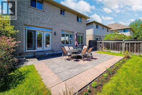 Brick exterior featuring multiple windows and a double glass-paned door - 197 Cloverleaf Drive, Ancaster, ON - Outdoor With Exterior