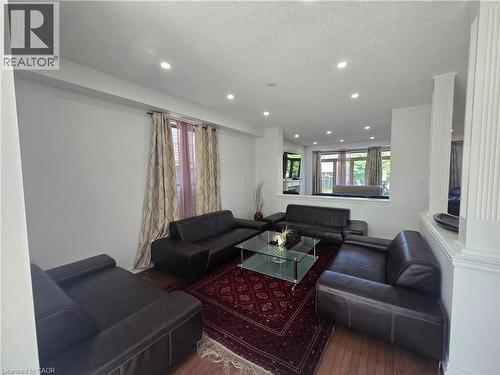 Bright interior space featuring recessed lighting and wood-finish flooring - 197 Cloverleaf Drive, Ancaster, ON - Indoor Photo Showing Living Room