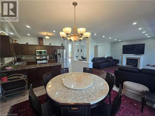 Open-concept living space featuring a formal dining area, kitchen, and living room - 197 Cloverleaf Drive, Ancaster, ON - Indoor
