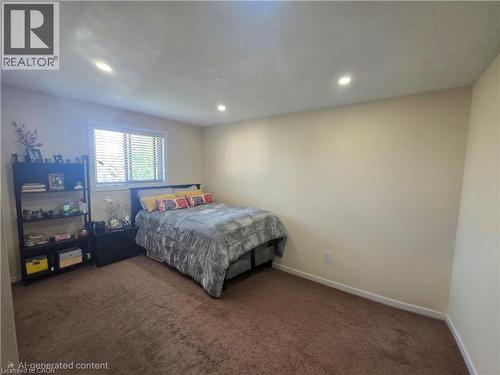 Bedroom featuring recessed ceiling lighting, a window with horizontal blinds, and neutral-toned wall paint - 197 Cloverleaf Drive, Ancaster, ON - Indoor Photo Showing Bedroom