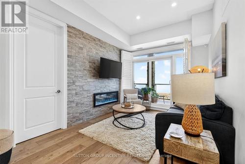 Walkout to Balcony - 209 - 764 River Road E, Wasaga Beach, ON - Indoor Photo Showing Living Room With Fireplace