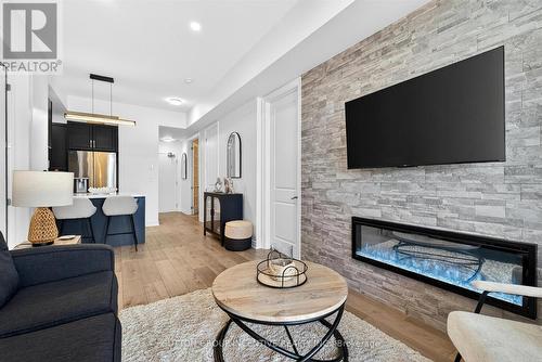 209 - 764 River Road E, Wasaga Beach, ON - Indoor Photo Showing Living Room With Fireplace