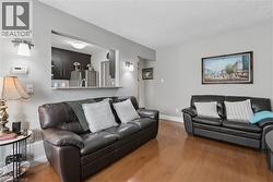Living area with wood-finish flooring and light gray walls - 