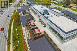 Rooftop terrace with paver flooring and glass panel railings - 