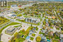 Aerial perspective of a mixed-use district featuring residential properties, commercial establishments, and multi-story apartment buildings - 