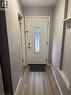 Entryway featuring a panel door with decorative glass inserts, wood-finish flooring, and light gray wall paint - 61 E Waterloo Drive Unit# 61, Kitchener, ON  - Indoor Photo Showing Other Room 