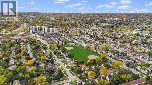 Aerial perspective showcasing residential homes, a park with sports fields, and distant multi-story buildings - 37 Delena Avenue S, Hamilton, ON - Outdoor With View