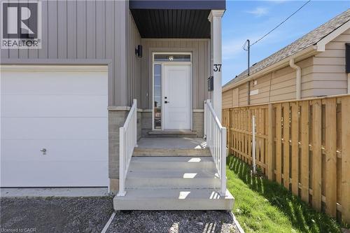 Front facade featuring vertical plank siding and stone accents - 37 Delena Avenue S, Hamilton, ON - Outdoor With Exterior