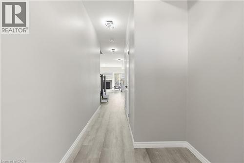 Hallway featuring wood-finish flooring, light grey walls, white baseboards, and recessed ceiling lighting - 37 Delena Avenue S, Hamilton, ON - Indoor Photo Showing Other Room