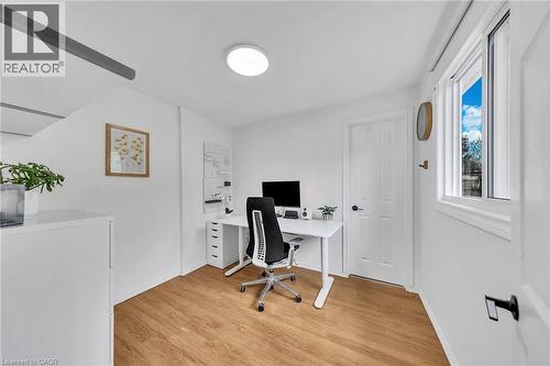 Dedicated workspace featuring wood-finish flooring, white walls, and a prominent window - 501 Ferguson Avenue N, Hamilton, ON - Indoor Photo Showing Office