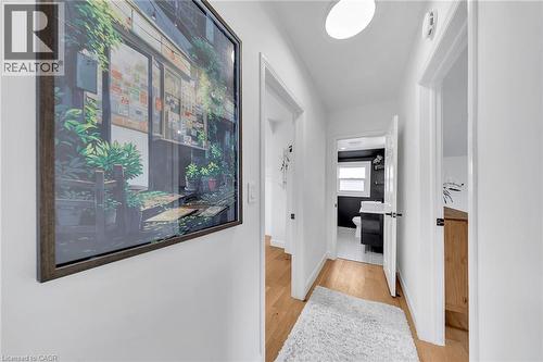 Bright hallway featuring wood-finish flooring, white walls, and a flush-mount ceiling light - 501 Ferguson Avenue N, Hamilton, ON - Indoor Photo Showing Other Room