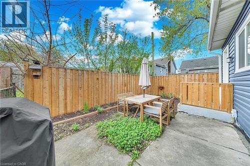 Private backyard featuring a concrete patio, wood privacy fencing, and a garden bed - 501 Ferguson Avenue N, Hamilton, ON - Outdoor