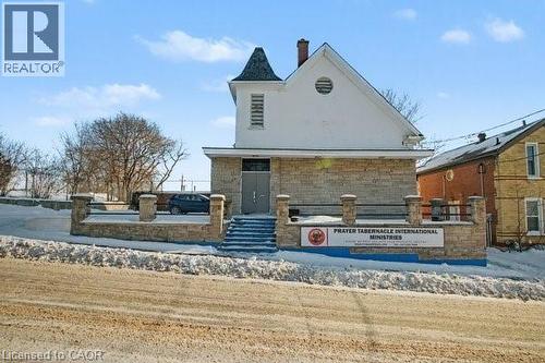 Stone-clad facade with a distinctive turret feature - 37 Wellington Street, Cambridge, ON 