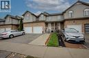 Townhome exterior featuring brick and siding facade, individual driveways, and attached garages - 53 Prosperity Drive, Kitchener, ON  - Outdoor With Facade 